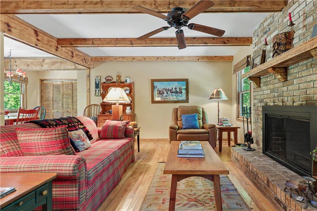 102 Moses Road Rabun Gap, GA 30568 - Photo 8 of 40 a living room with furniture and a fireplace