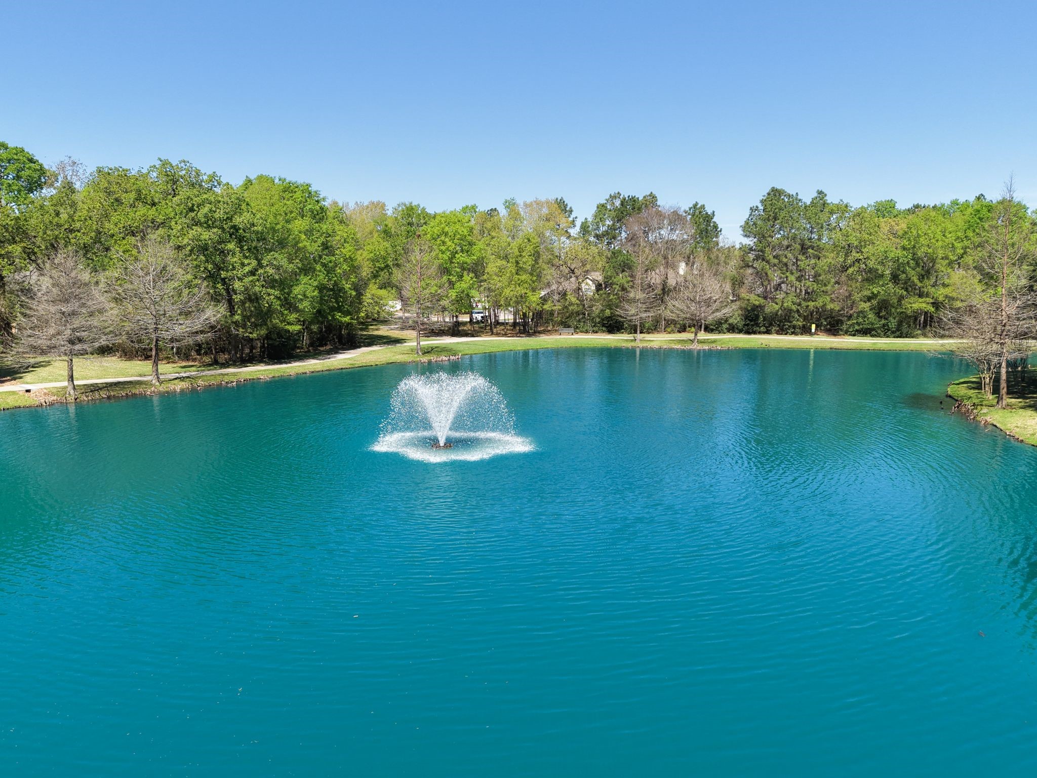 7 Sovereign Way Conroe, TX 77384 - Photo 24 of 31 a view of a lake with houses in outdoor space