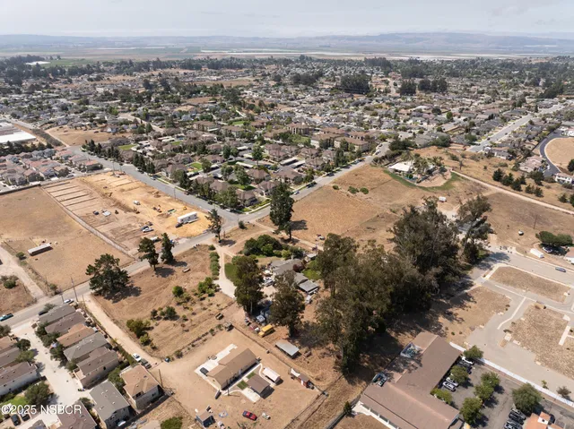 an aerial view of a house with a yard