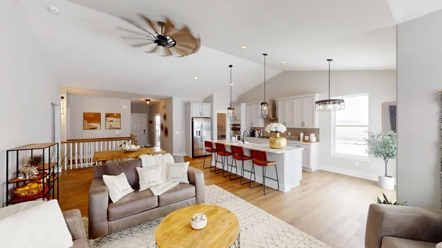 a living room with kitchen island furniture and a chandelier
