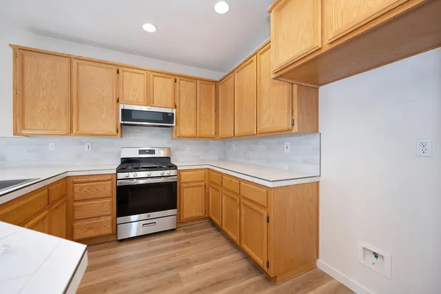 a view of a kitchen with wooden floor