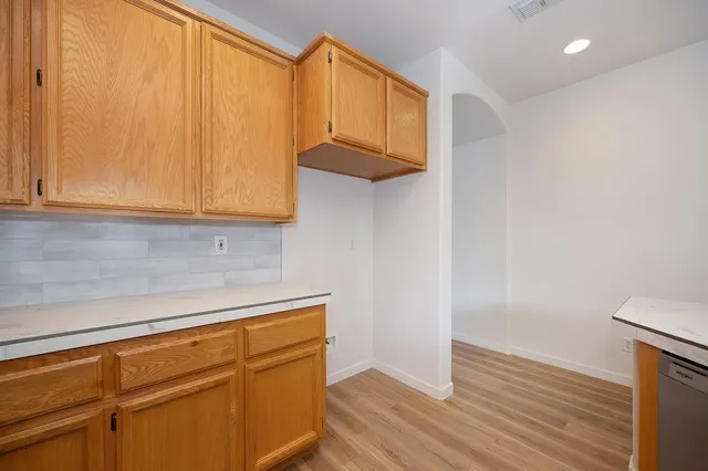 a kitchen with stainless steel appliances granite countertop a sink and a window