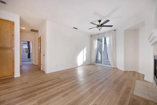 a view of a kitchen with wooden floor and a window