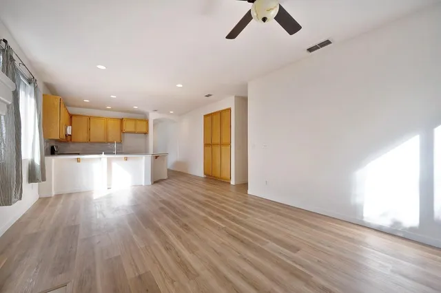 a view of a room with kitchen and fireplace