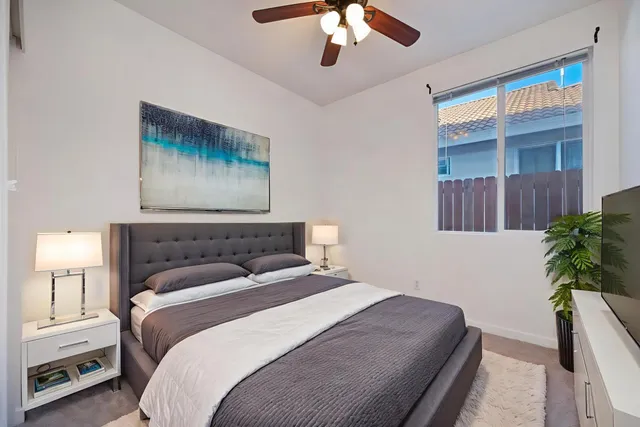 an empty room with chandelier fan