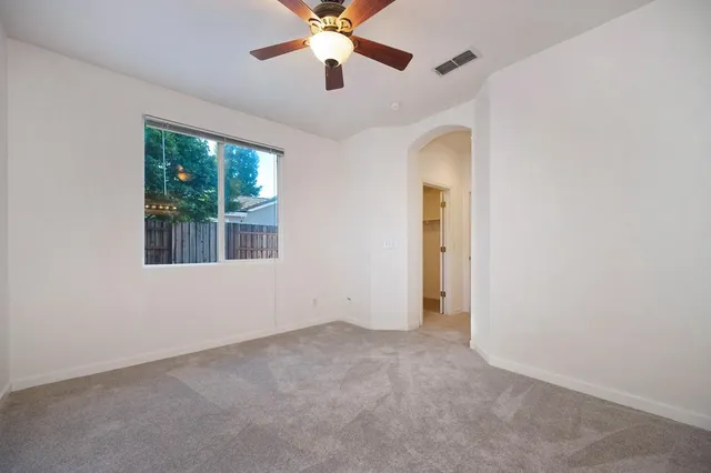 a bathroom with a granite countertop sink a mirror and a shower
