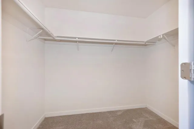 a view of a pathway of a house with wooden fence