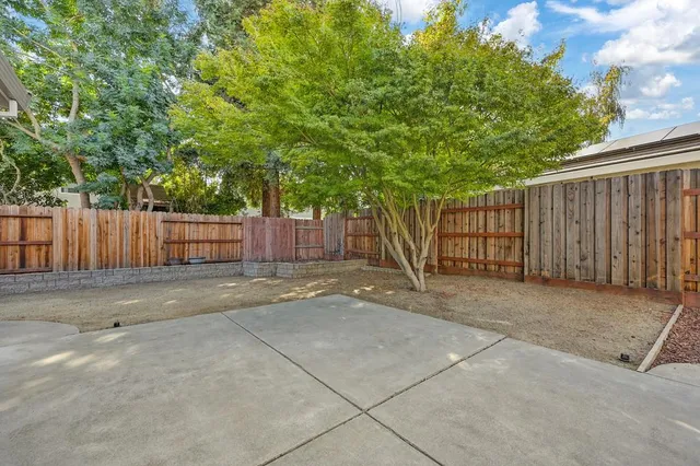a yellow house with trees in front of it