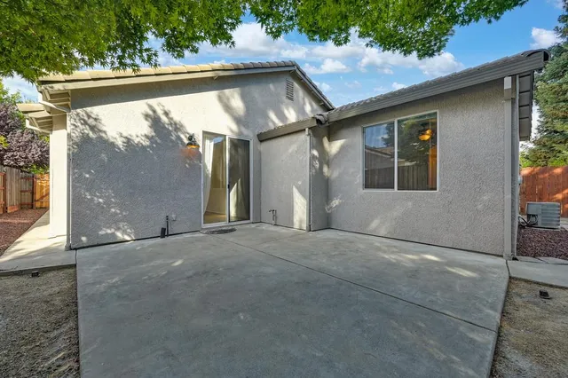 a view of a house with backyard and tree