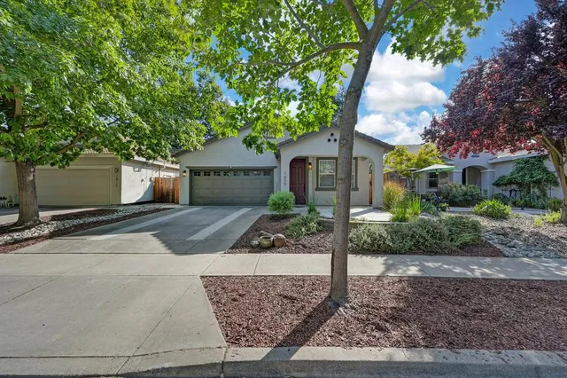 a front view of a house with garden