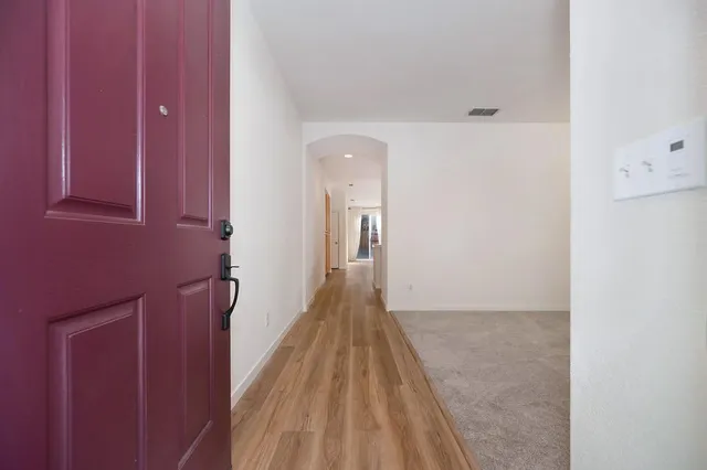 a view of a hallway with wooden floor