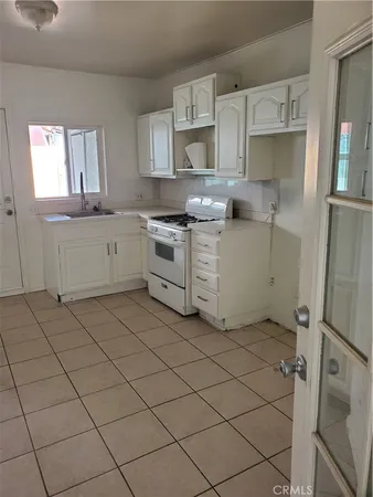 a kitchen with a stove a sink and a microwave