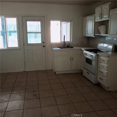 a kitchen with a stove a sink and a microwave