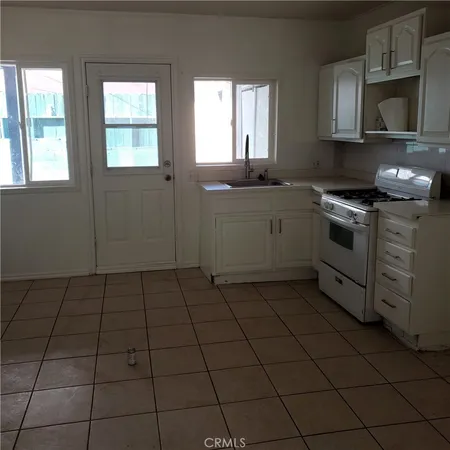a kitchen with stainless steel appliances a stove a sink and a microwave
