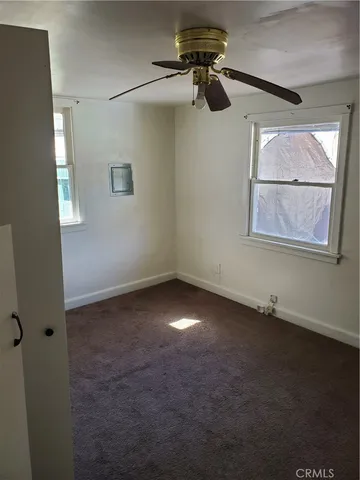 a view of room with a ceiling fan and window