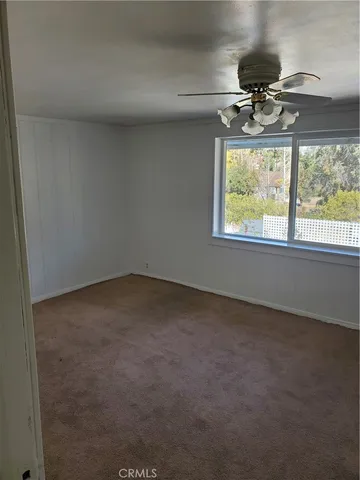 a bathroom with a granite countertop sink a toilet and a mirror