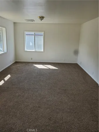 an empty room with a empty space and windows