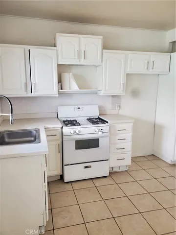 a kitchen with cabinets and white appliances