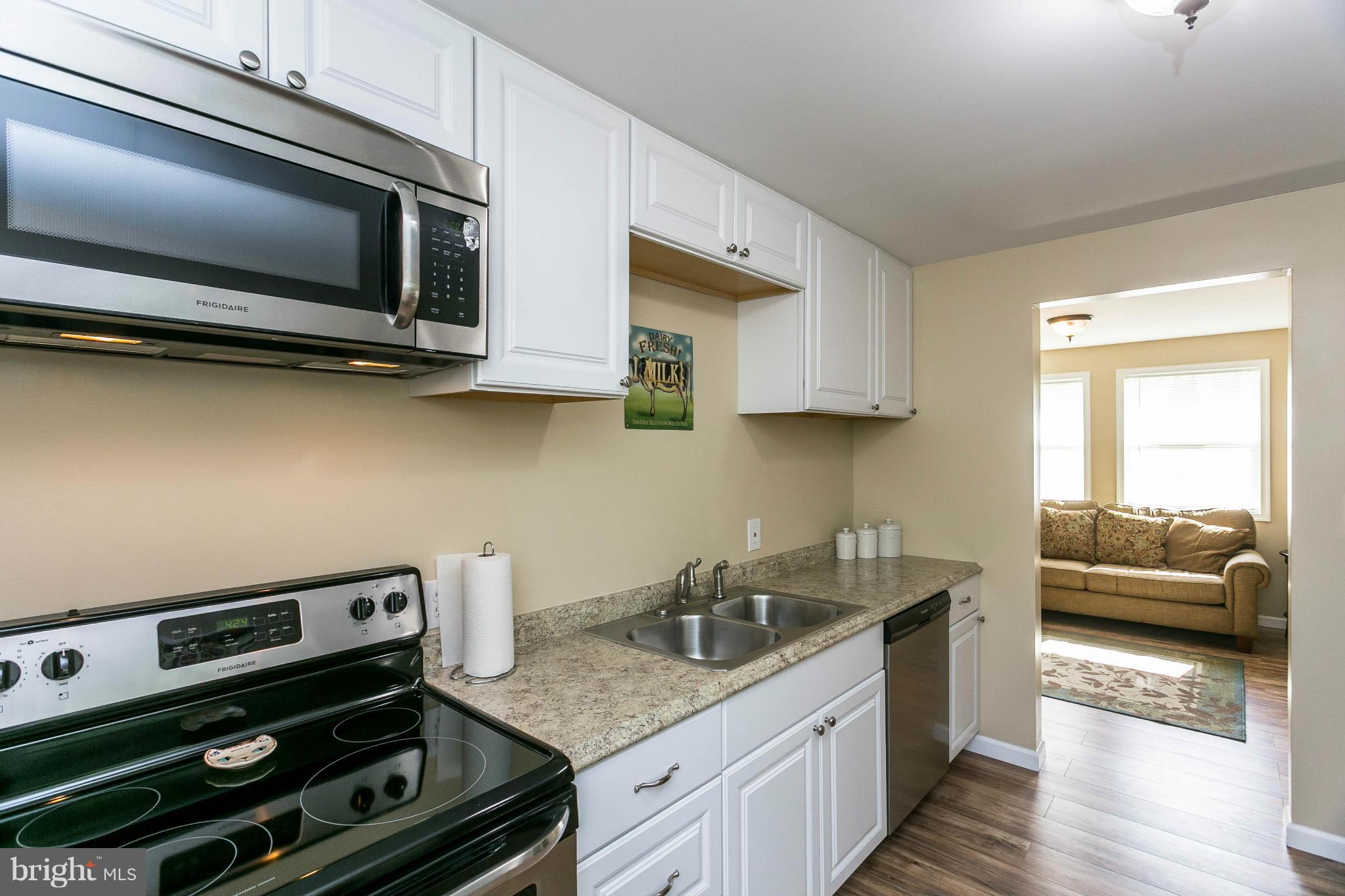 207 South Reymann Street Ranson, WV 25438 - Photo 11 of 24 a kitchen with a stove and a microwave