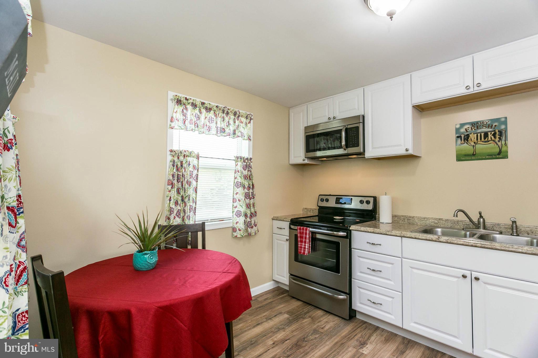 207 South Reymann Street Ranson, WV 25438 - Photo 12 of 24 a kitchen with stainless steel appliances kitchen island granite countertop a stove a sink and a microwave