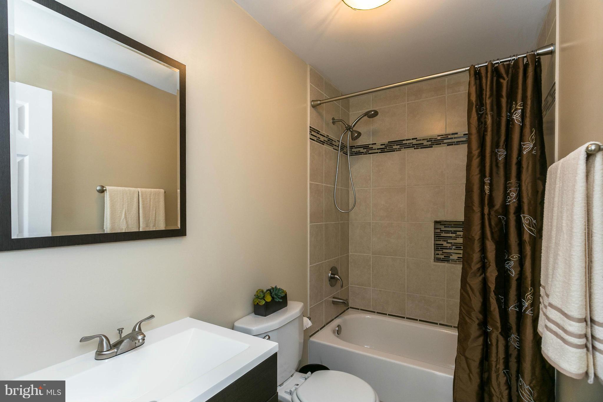 207 South Reymann Street Ranson, WV 25438 - Photo 15 of 24 a bathroom with a sink toilet and shower