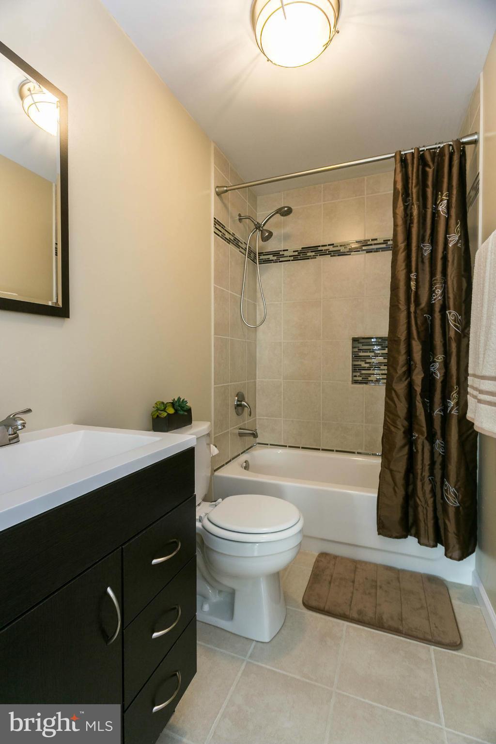 207 South Reymann Street Ranson, WV 25438 - Photo 17 of 24 a bathroom with a double vanity sink toilet and shower