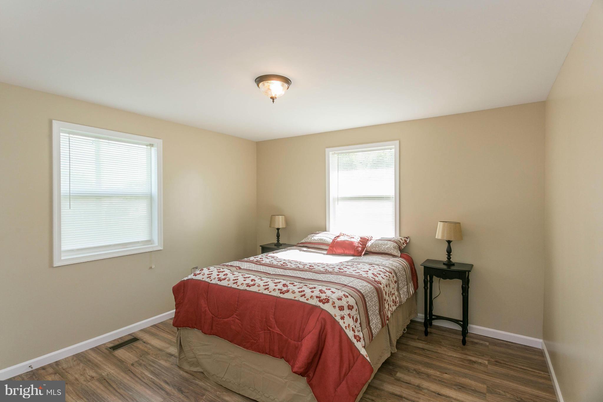 207 South Reymann Street Ranson, WV 25438 - Photo 18 of 24 a bedroom with a bed and wooden floor