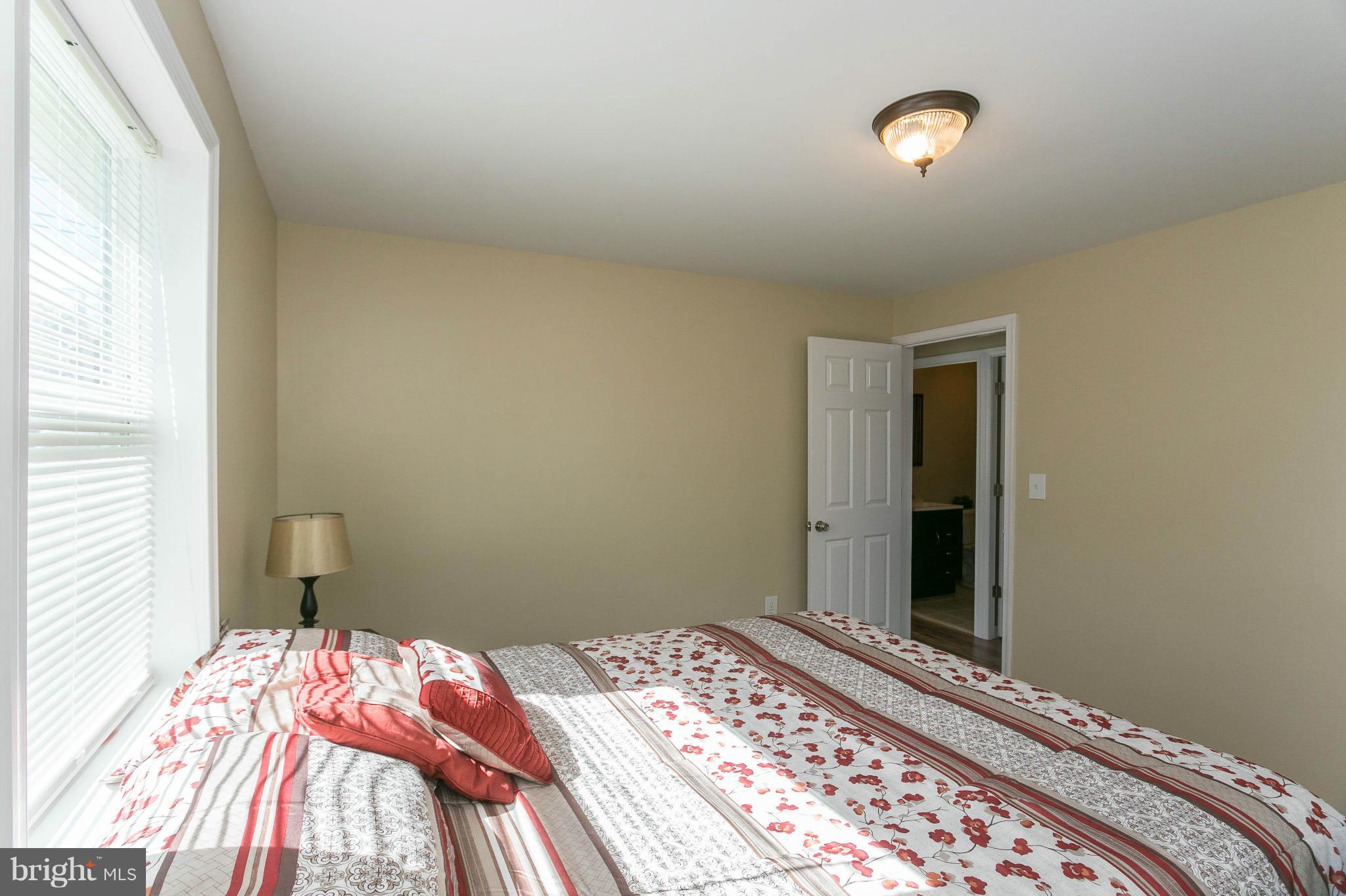 207 South Reymann Street Ranson, WV 25438 - Photo 19 of 24 a bedroom with a bed and a window