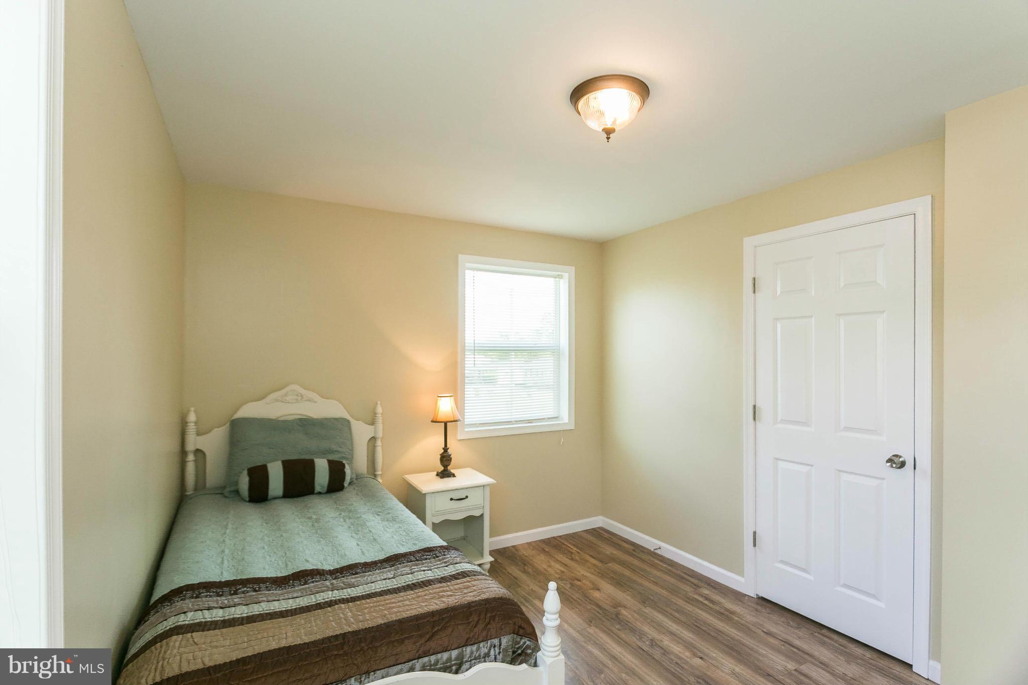 207 South Reymann Street Ranson, WV 25438 - Photo 21 of 24 a bedroom with a bed and wooden floor