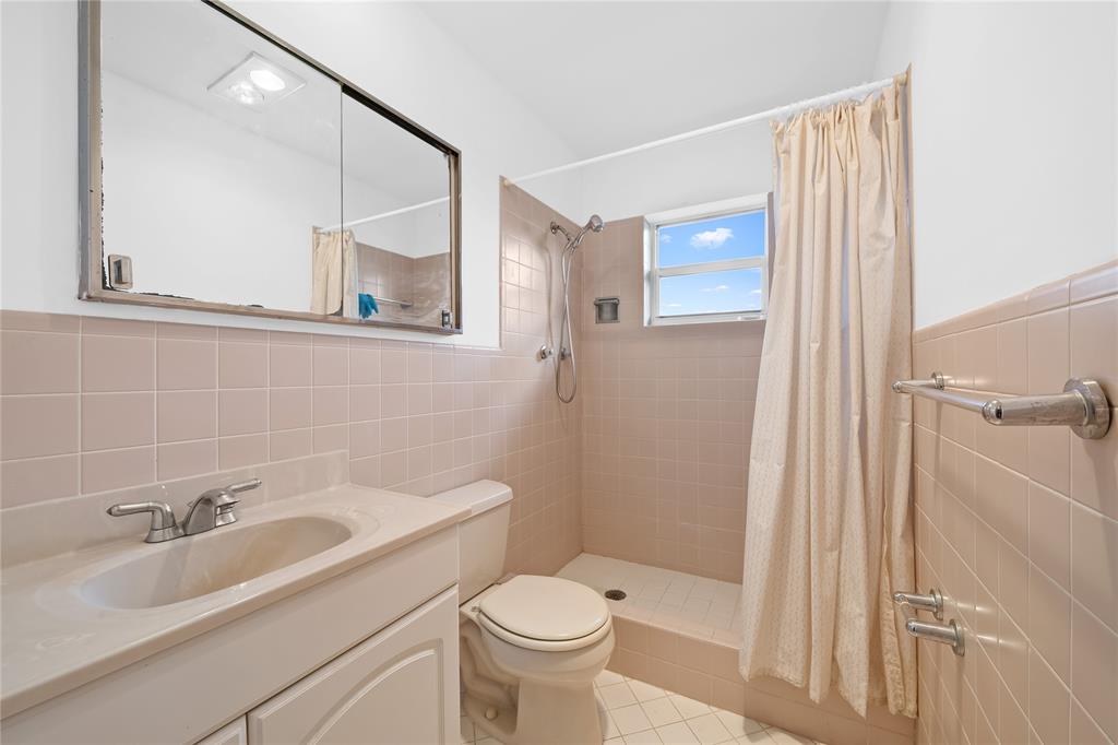 2501 South Ocean Boulevard, Unit 301 Boca Raton, FL 33432 - Photo 14 of 32 a bathroom with a sink toilet and shower