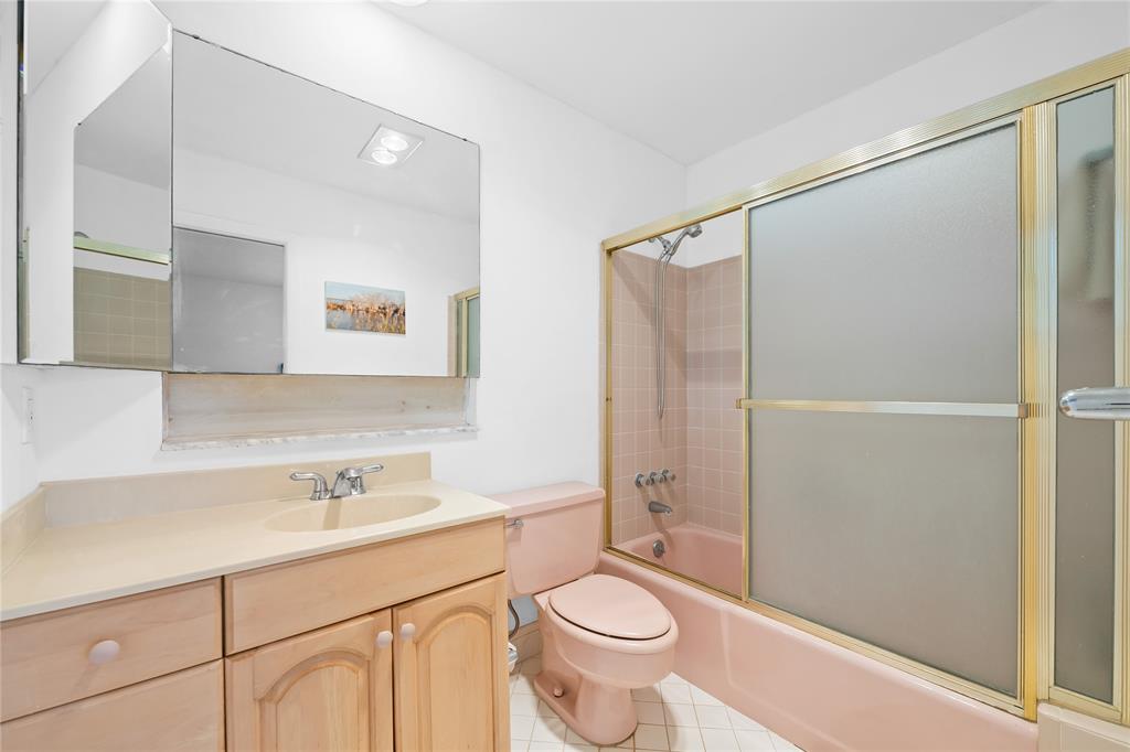 2501 South Ocean Boulevard, Unit 301 Boca Raton, FL 33432 - Photo 15 of 32 a bathroom with a sink toilet a mirror and shower