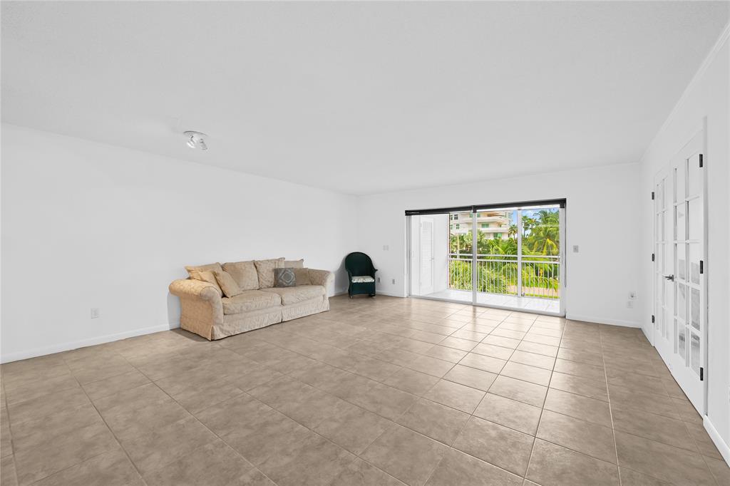2501 South Ocean Boulevard, Unit 301 Boca Raton, FL 33432 - Photo 18 of 32 a living room with furniture and a large window
