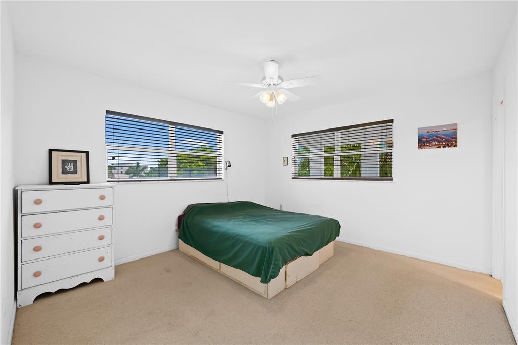 2501 South Ocean Boulevard, Unit 301 Boca Raton, FL 33432 - Photo 29 of 32 a bedroom with a bed and a dresser