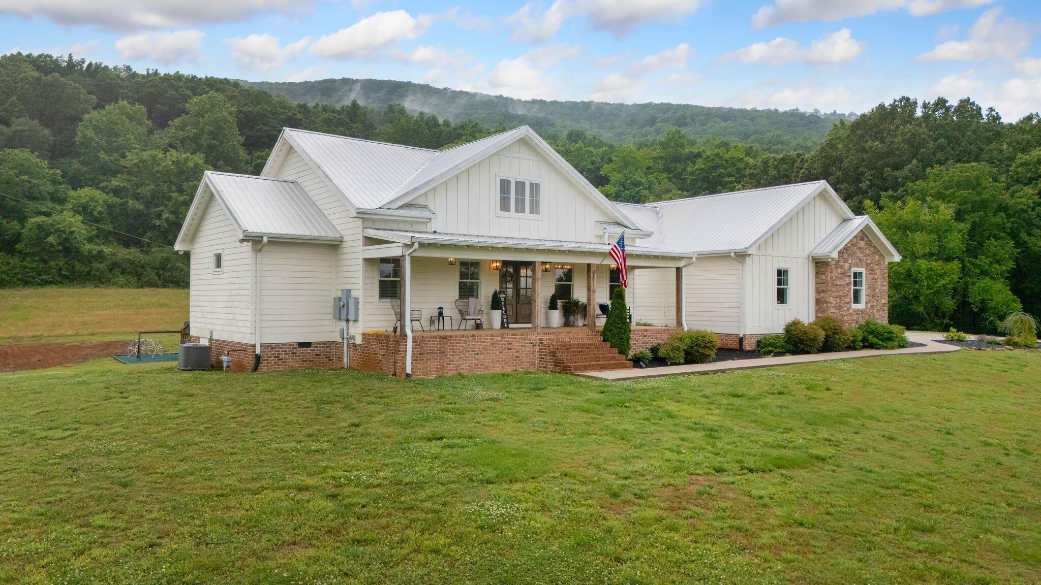 6866 Daus Mountain Road Whitwell, TN 37397 - Photo 43 of 49 a front view of a house with a yard and garage