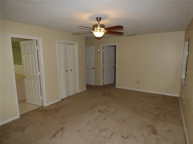 a view of a chandelier fan and entryway