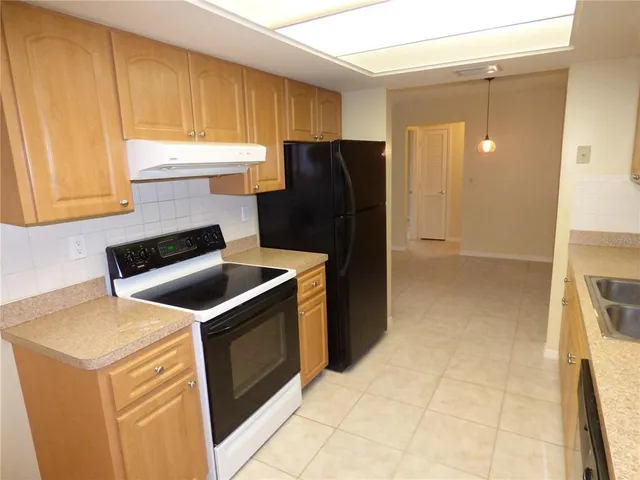 a kitchen with a stove refrigerator and cabinets