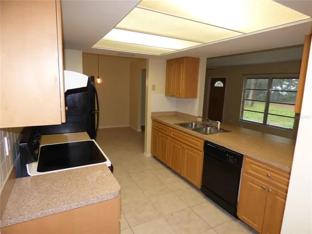 a kitchen with a refrigerator and a sink
