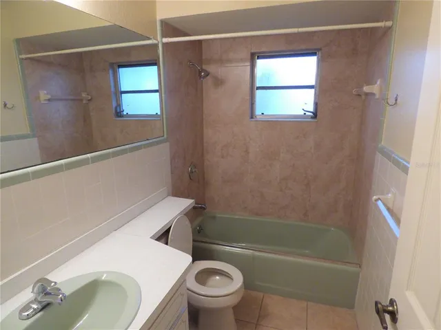 a bathroom with a sink a toilet and a bathtub