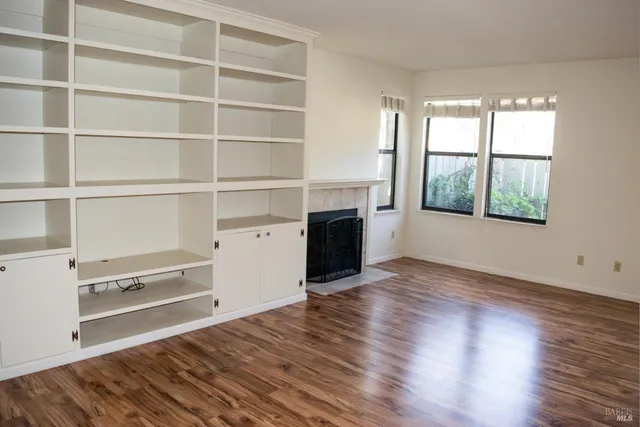 a view of a kitchen with wooden floor and a window