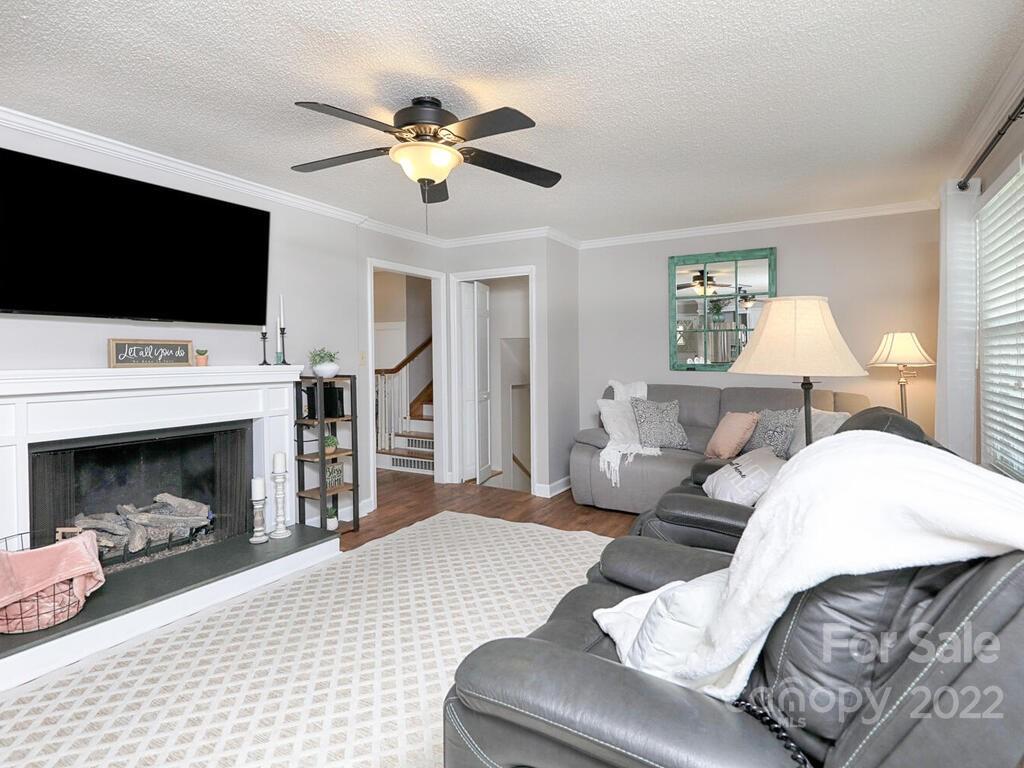 5600 Wright Road Kannapolis, NC 28081 - Photo 17 of 45 a living room with furniture a flat screen tv and a fireplace