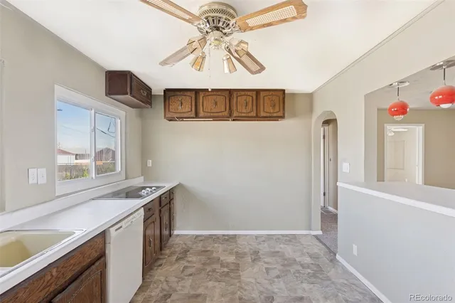 a kitchen with stainless steel appliances granite countertop a sink and a granite counter tops with a large window