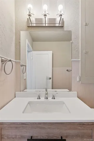 a bathroom with a sink and a mirror