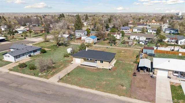 an aerial view of a residential houses with outdoor space and parking
