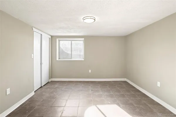 an empty room with a empty space and windows