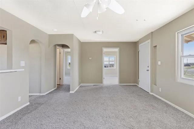 an empty room with windows and closet