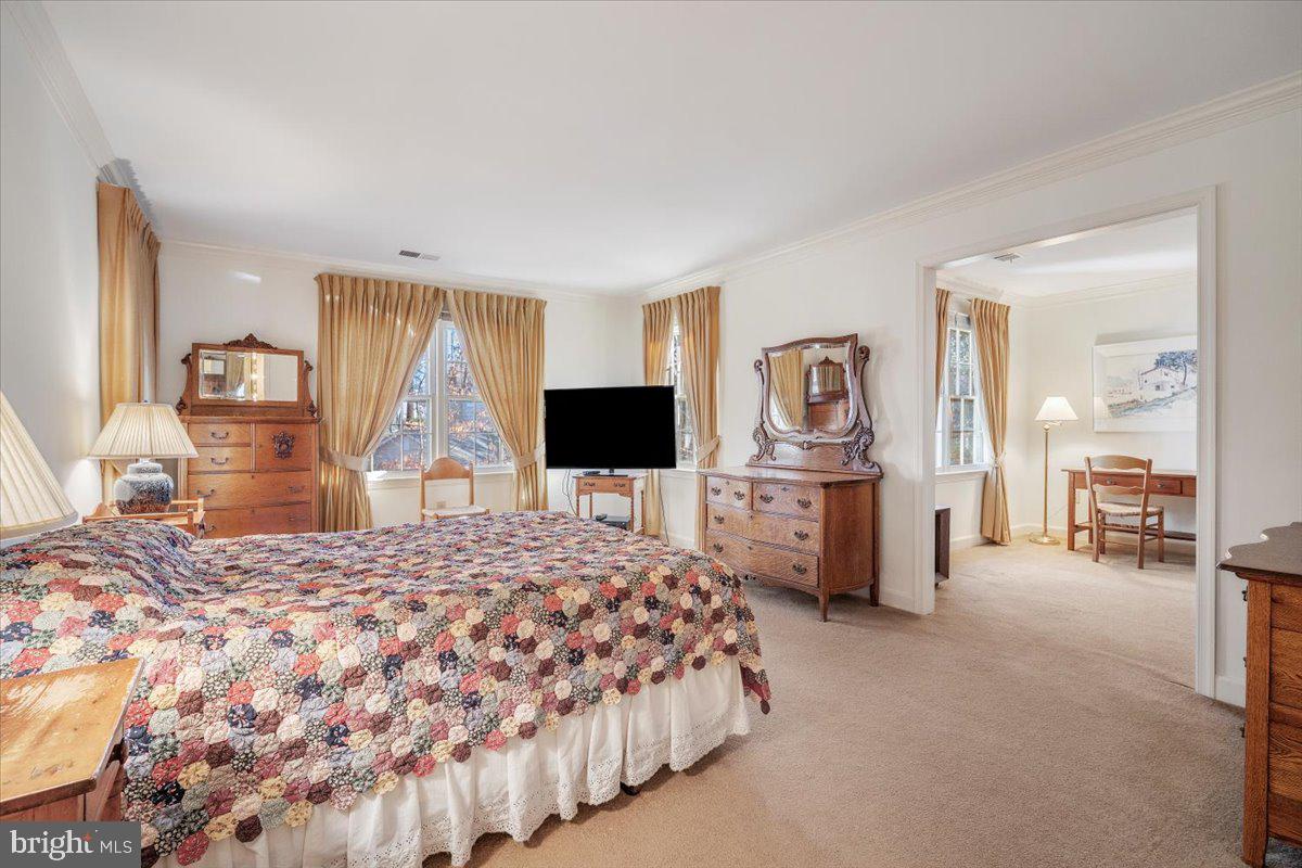2 Candlelight Court Potomac, MD 20854 - Photo 28 of 58 a bedroom with a large bed and a flat tv screen on dresser