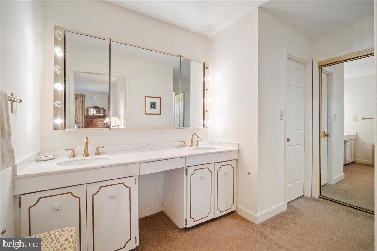 2 Candlelight Court Potomac, MD 20854 - Photo 30 of 58 a bathroom with a double vanity sink and mirror