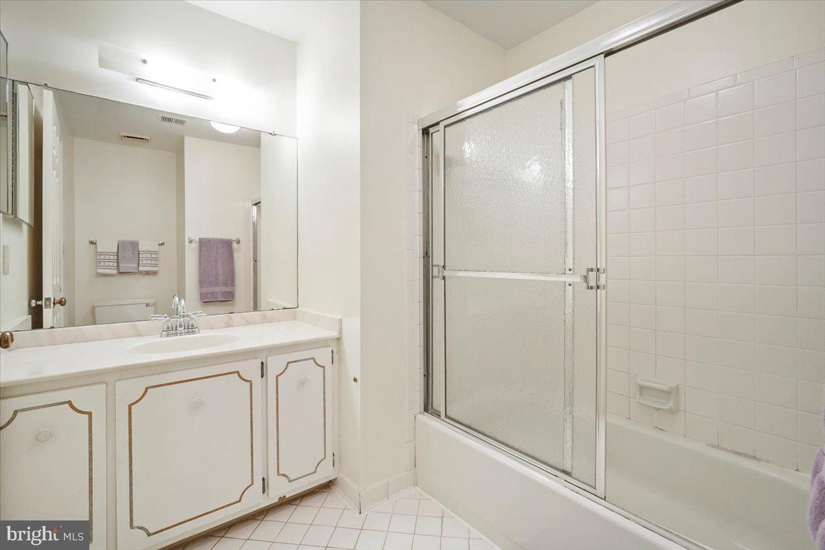 2 Candlelight Court Potomac, MD 20854 - Photo 36 of 58 a bathroom with a double vanity sink mirror and shower