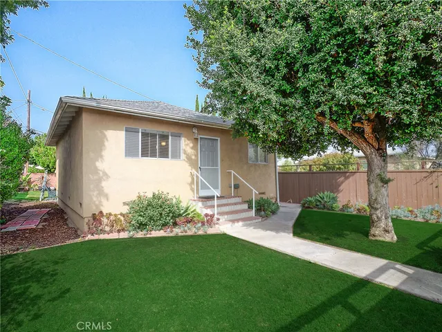 a front view of house with yard and green space