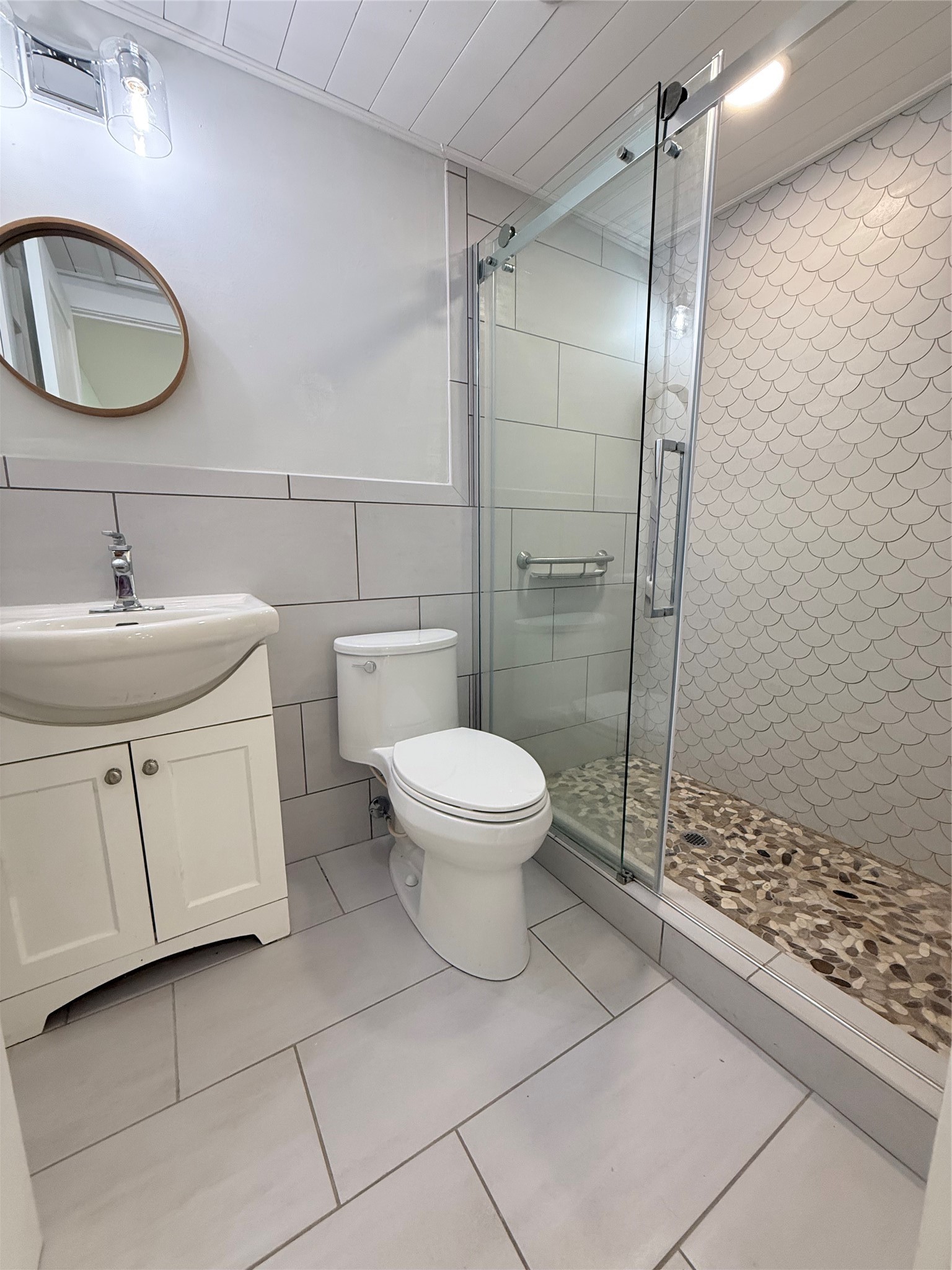2154 County Road 230 Sargent, TX 77414 - Photo 24 of 30 a bathroom with a granite countertop toilet a sink and a mirror